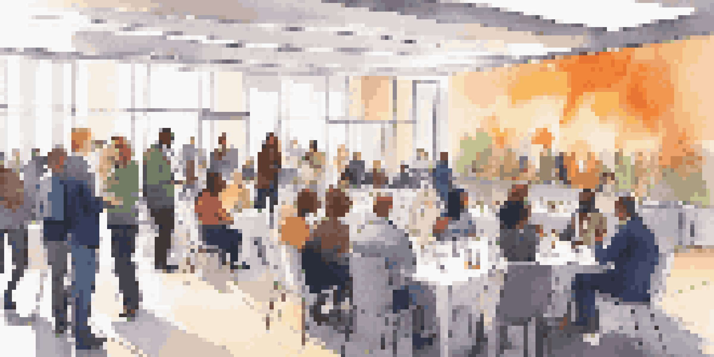 A vibrant networking event with diverse individuals engaged in conversation in a well-lit conference hall.