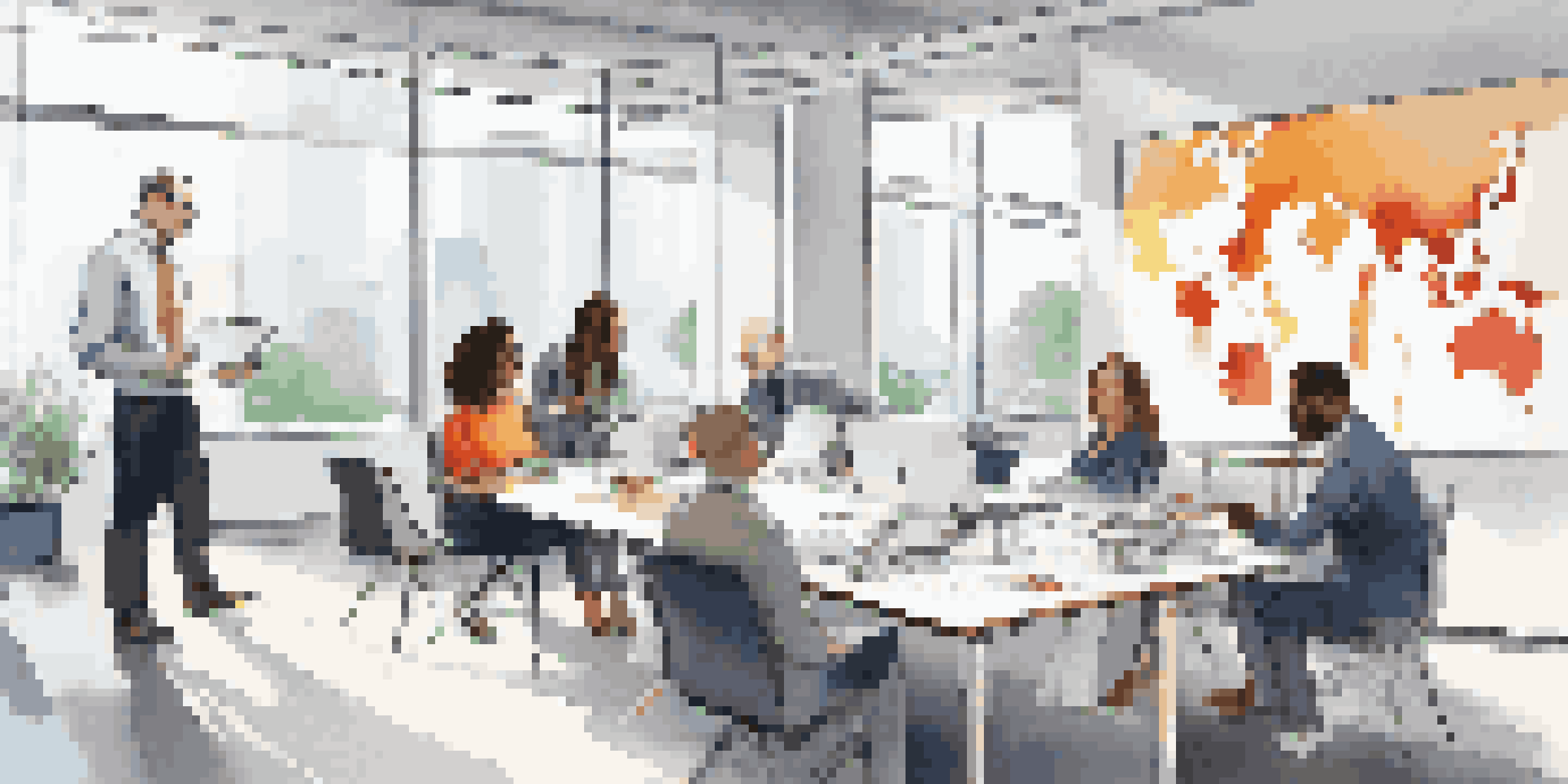 A diverse group of professionals in a modern office meeting room, collaborating with laptops and notes.