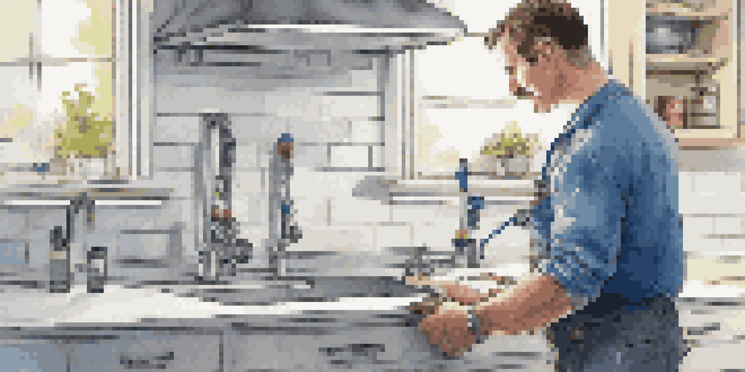 A plumber working with an AI diagnostic tool in a modern kitchen, showing a digital display for leak detection.