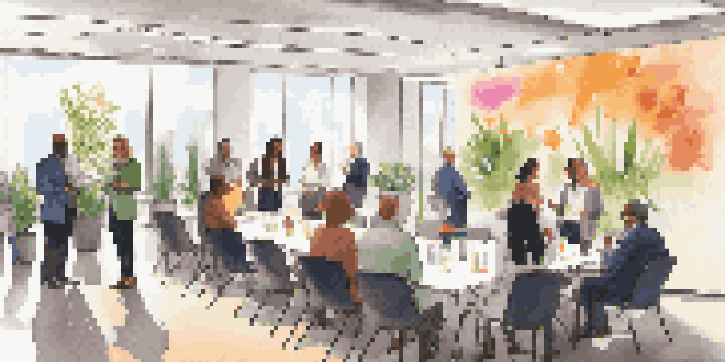 A diverse group of professionals networking in a bright conference room, engaging in conversations with name tags on.