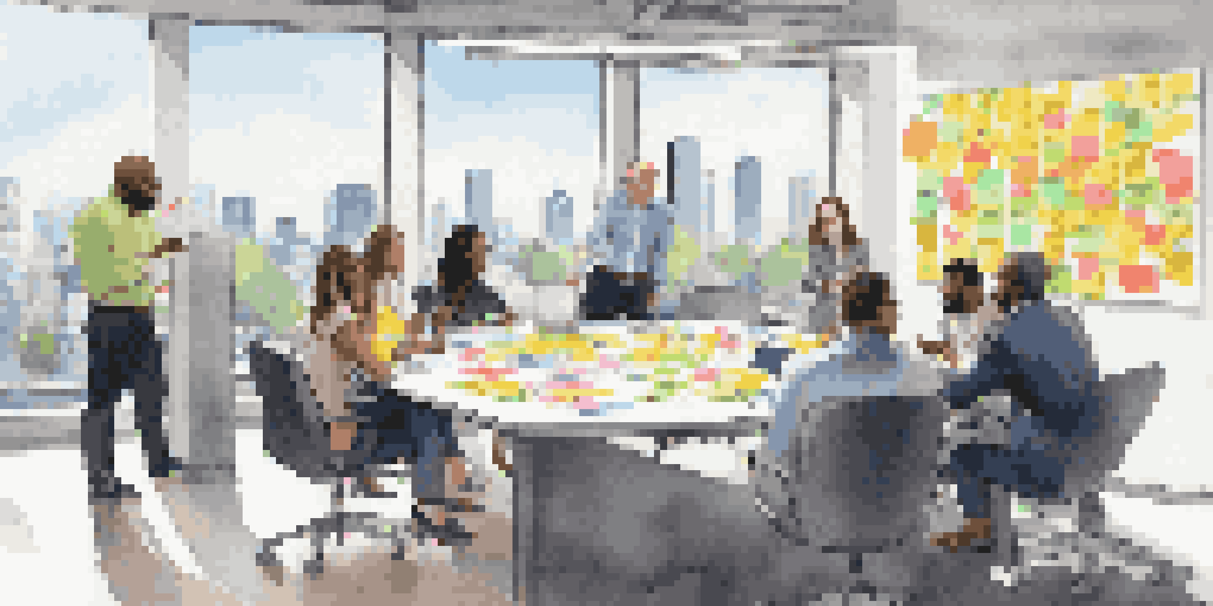 A diverse group of professionals collaborating in a bright conference room, sharing ideas around a table.