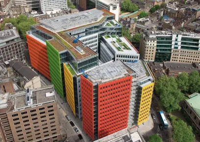 An aerial view of a large colorful building in the middle of a city