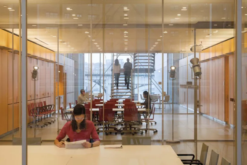 a woman is sitting at a table in a conference room .