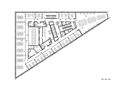 a black and white floor plan of an office building with tables and chairs .