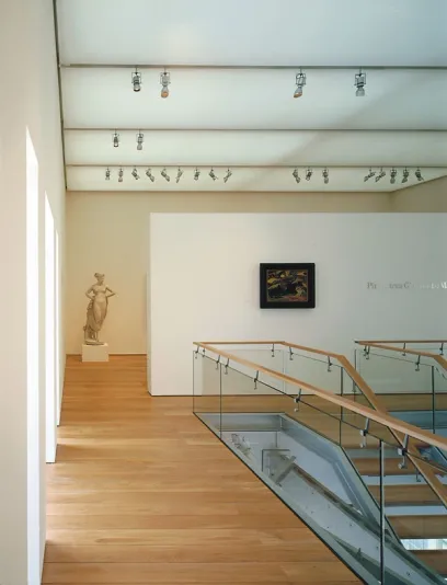 A staircase leading up to the second floor of a museum