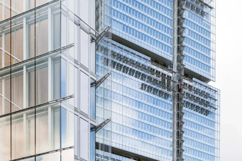 a close up of a tall building with a lot of windows on a white background .