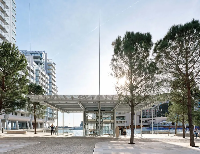 A large building with a lot of windows and trees in front of it