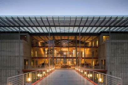 a large building with a glass roof and a bridge leading to it .