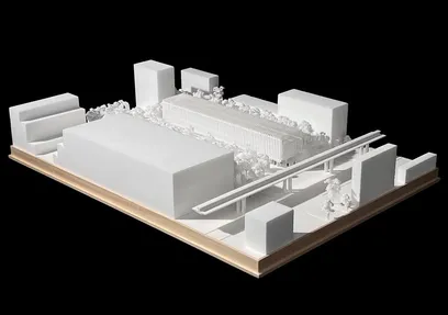 Scientific device on a clear acrylic board with etched lines, featuring vertical channels containing blue, yellow, and red liquids.