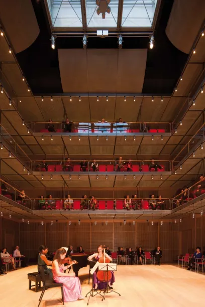 Two people are walking down stairs in front of a glass building
