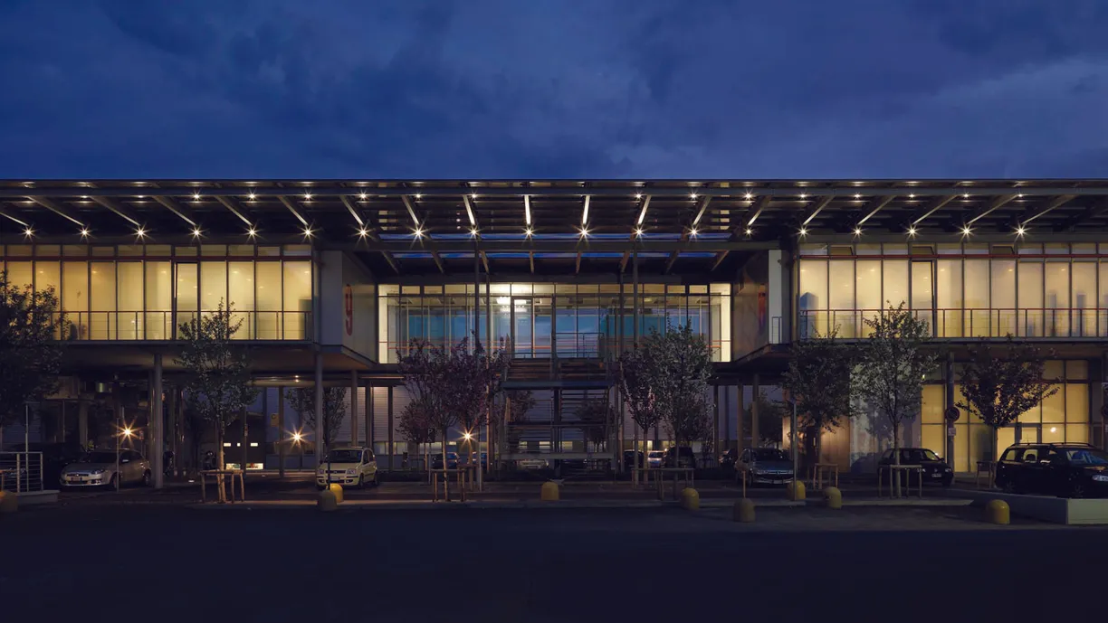 a large building with a lot of windows is lit up at night .