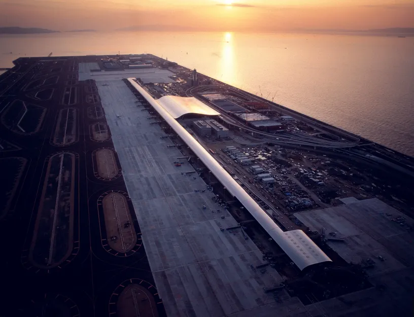 An aerial view of an airport runway at sunset