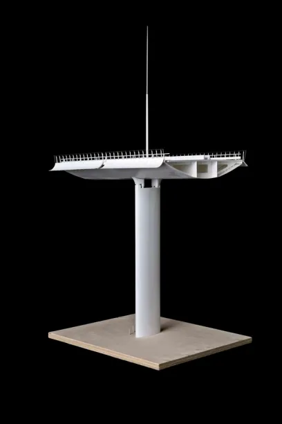 A model of a bridge is sitting on a wooden base