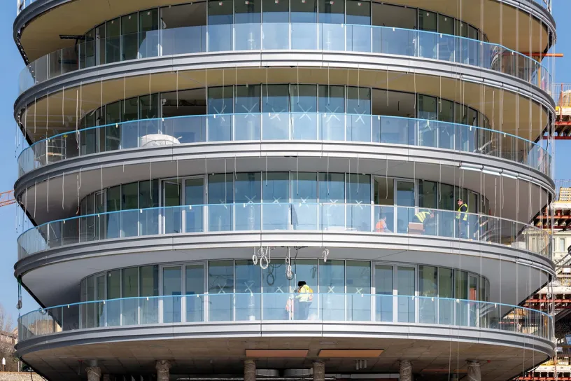 A building under construction with a lot of windows and balconies