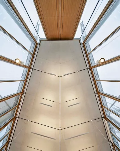 looking up at the ceiling of a building with lots of windows