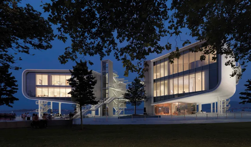 A large building with a lot of windows is lit up at night