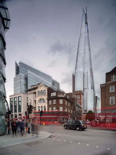 a busy city street with a tall building in the background