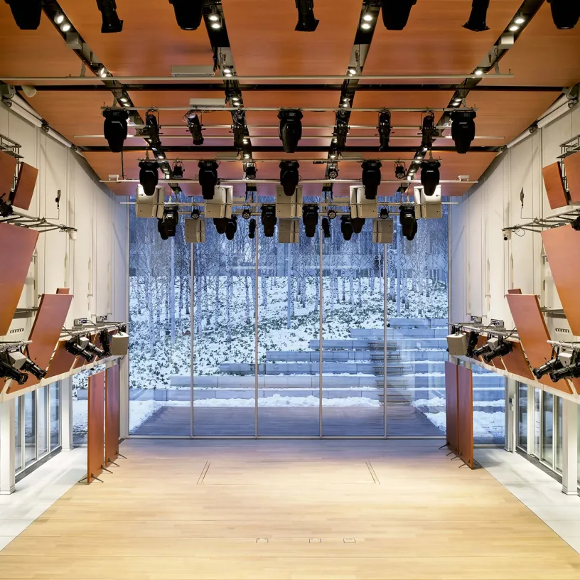 A large room with a lot of lights hanging from the ceiling