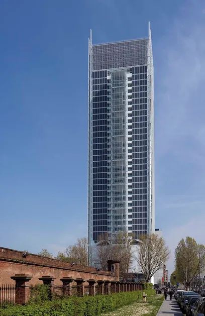 a large group of people are standing in front of a tall building .