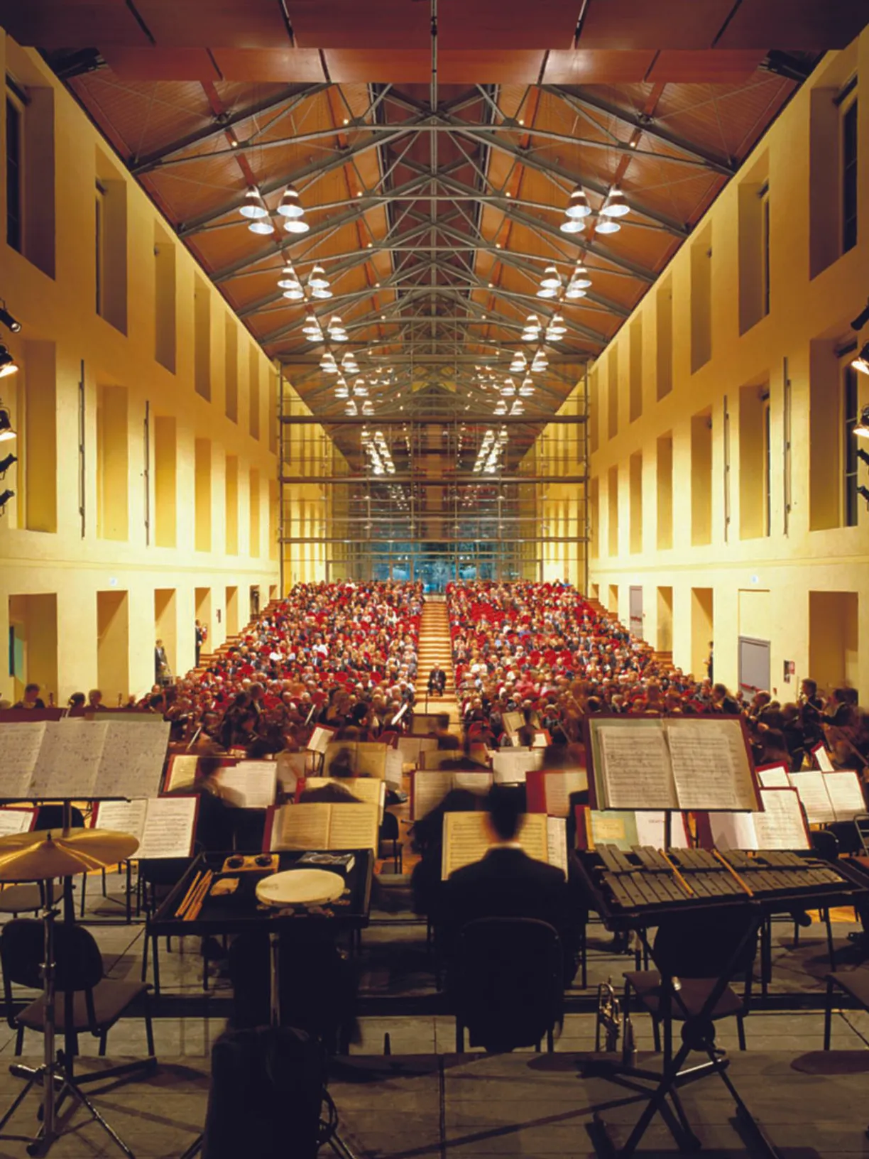 an orchestra is playing in front of a large crowd