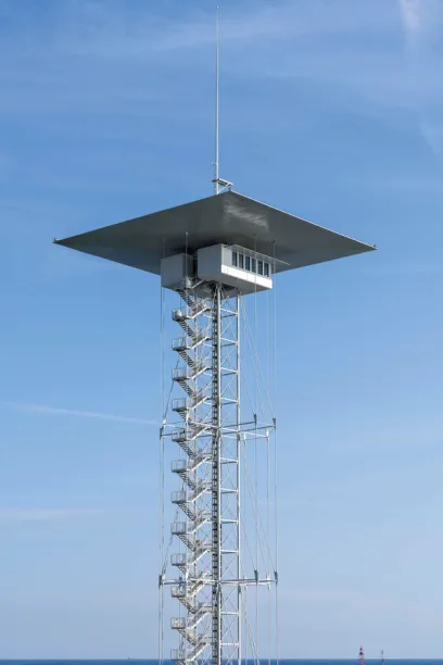 A very tall tower with stairs leading up to it