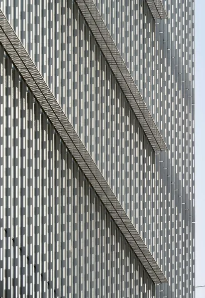 A gray and white building with stairs on the side