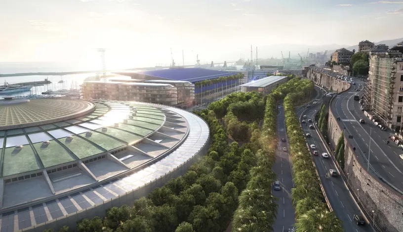 An aerial view of a large stadium surrounded by trees and a highway
