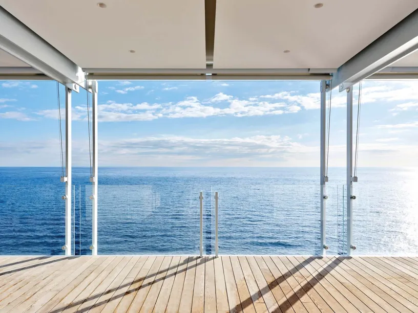 There is a large window with a view of the ocean