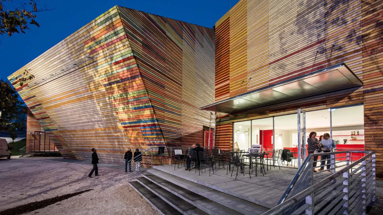 a group of people are standing outside of a building .