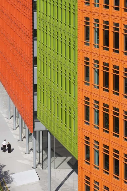 A green building is next to an orange building