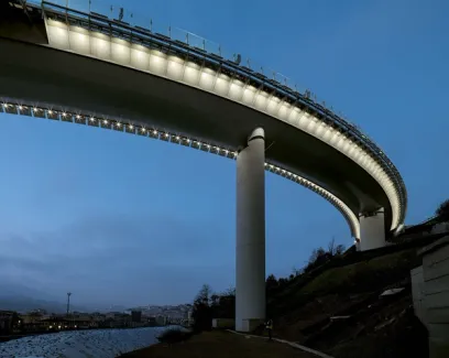 A bridge over a river at night with a lot of lights on it