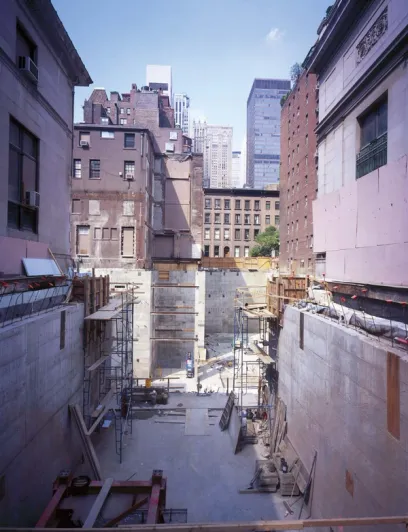 A construction site with a lot of scaffolding and buildings in the background