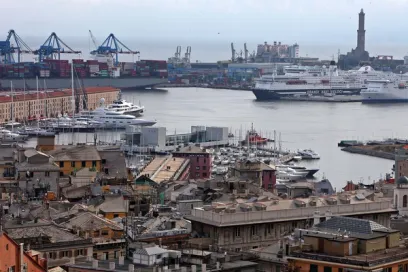 An aerial view of a city with a large ship in the water