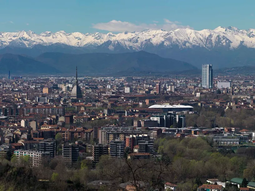 an aerial view of a city with mountains in the background .