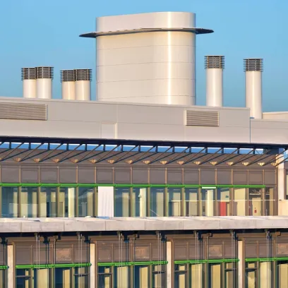 A building with a lot of windows and a chimney on top