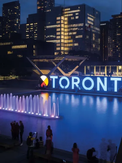 A fountain in front of a building that says toronto