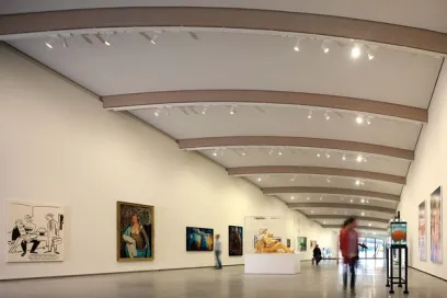 A large room filled with paintings and sculptures in a museum