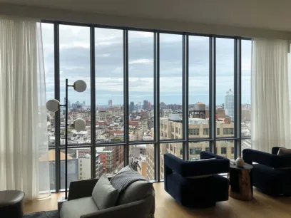 a living room with a view of the city through a large window .