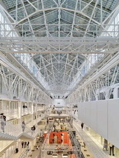 A large building with a roof that has solar panels on it