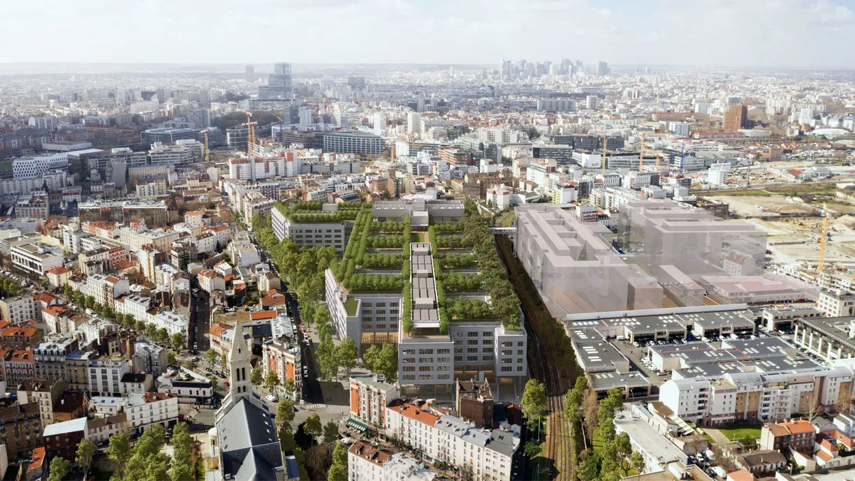 Aerial view of a city featuring a modern urban development with extensive green roofs and courtyards, flanked by older buildings and a distant skyline.