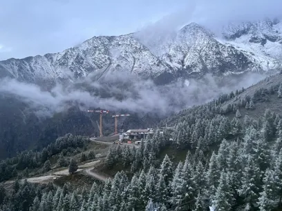a group of people are walking down a snow covered road
