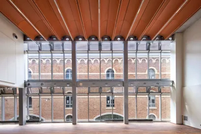 A large room with a lot of windows and a brick building in the background