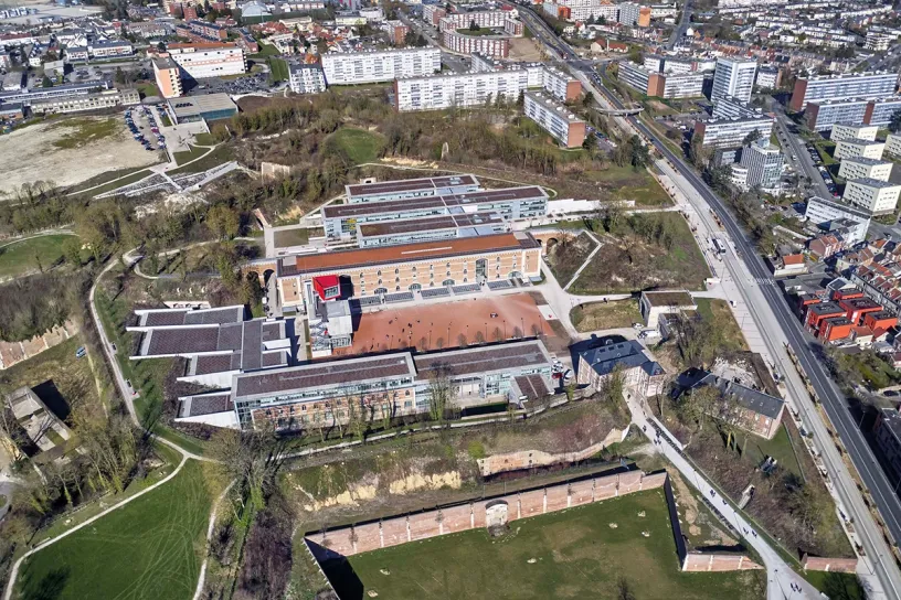 An aerial view of a large building in the middle of a city