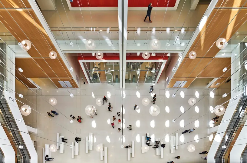 An aerial view of a large building with people walking around
