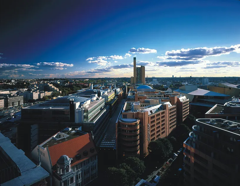 An aerial view of a city with a lot of buildings and a blue sky