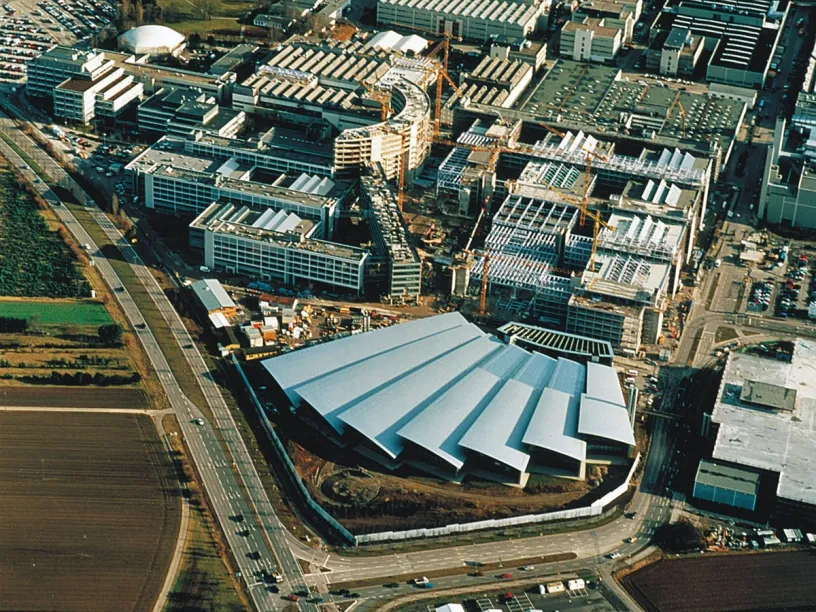 An aerial view of a large building under construction in a city