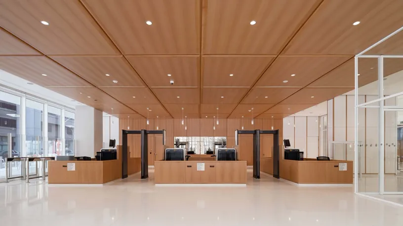 A large lobby with wooden tables and a wooden ceiling