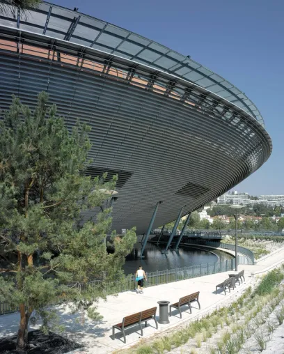 A man walking in front of a large building