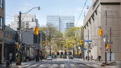 A busy city street with a lot of traffic and buildings in the background