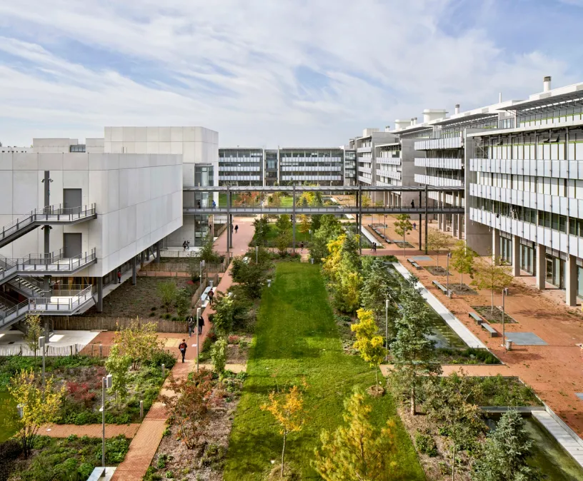 an aerial view of a large building with a park in the middle of it .